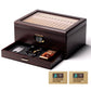 Ebony cigar humidor with open accessory drawer, showing storage for cutters, ashtrays, and lighters, with Boveda humidity packs included.