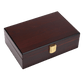 A closed, rectangular wooden cigar humidor with a glossy dark reddish-brown finish, featuring a gold-colored metal clasp at the front center.