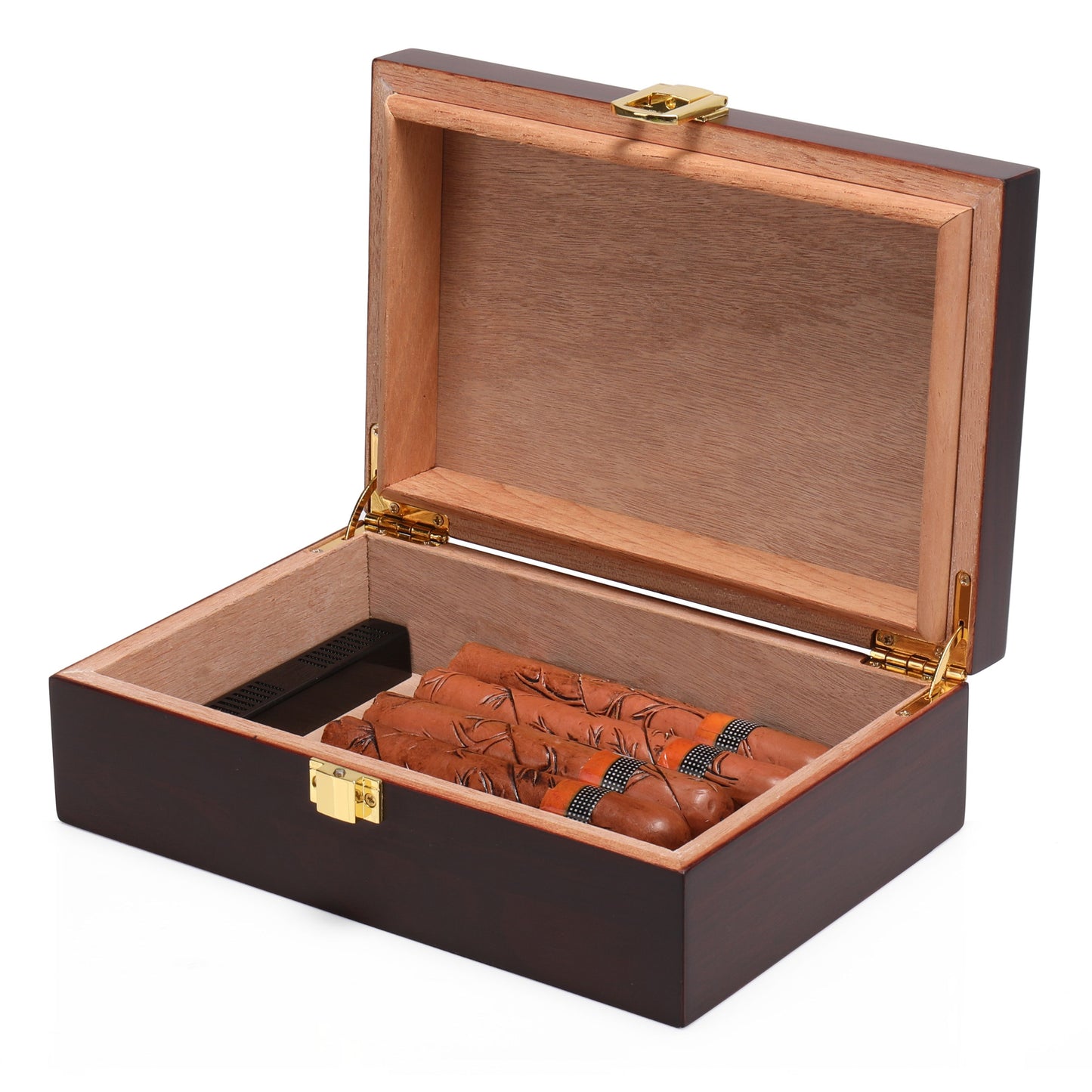An open wooden cigar humidor revealing its light brown cedar wood interior lining, with several cigars neatly arranged inside, alongside a black humidifier device.