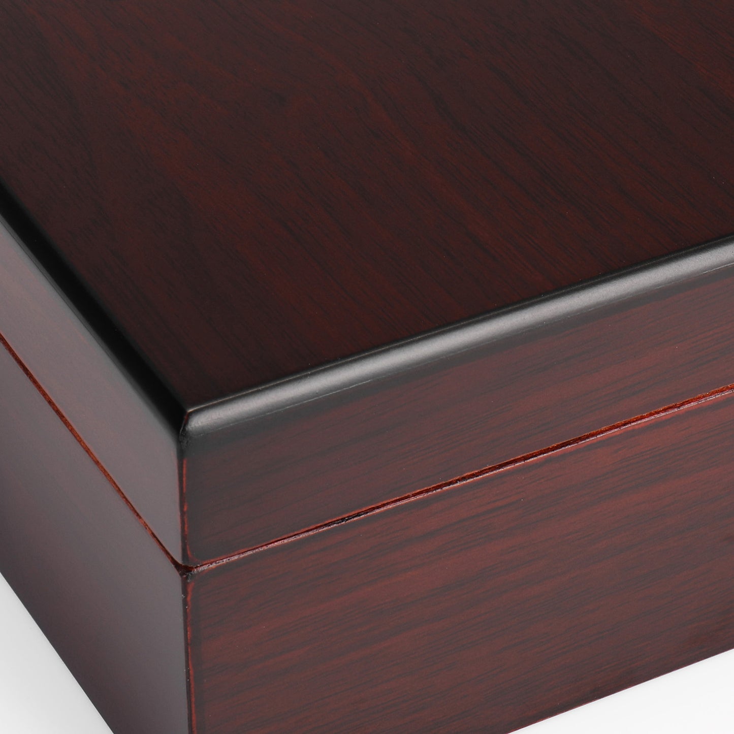 A detailed close-up of the exterior corner of the cigar humidor, showcasing the smooth, glossy dark reddish-brown wood grain and precise joinery.