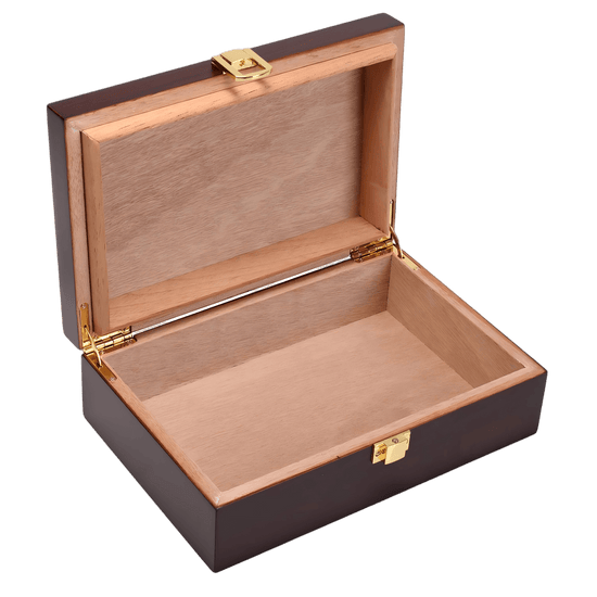 An empty, open cigar humidor revealing its full light brown cedar wood interior, with gold-colored metal hinges and a front clasp visible.