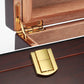 A split close-up of the cigar humidor’s gold-colored metal hinge (top) and front clasp (bottom), highlighting their polished finish and sturdy construction.