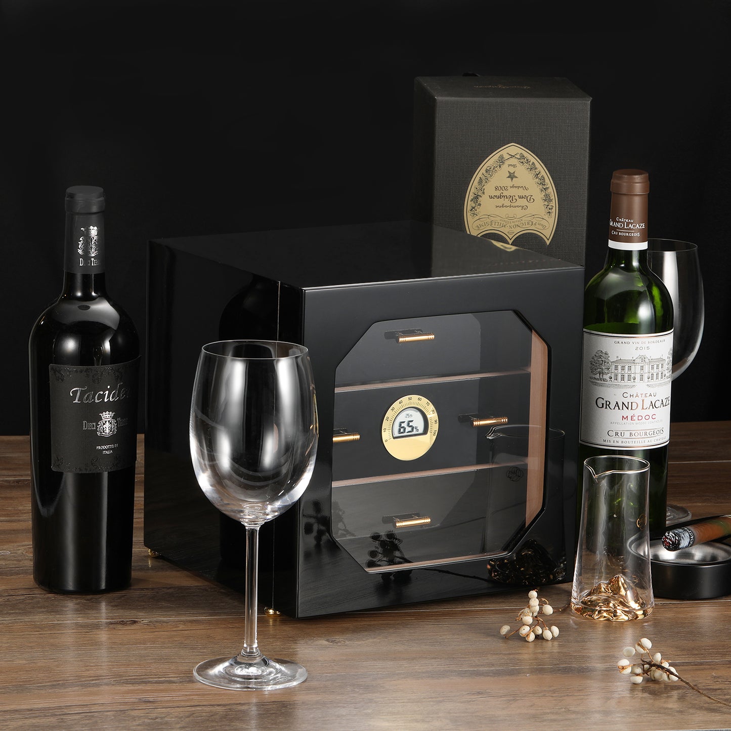 Glossy black cigar humidor displayed with wine and cigar accessories, perfect for luxury home bar decor and gifting to cigar lovers.