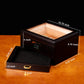 A technical infographic displaying the humidor’s external dimensions (10.75" × 9.25" × 4") and accessory drawer dimensions (9" × 8.25" × 1.2"), with cigars visible inside.