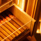 Warm LED lighting illuminates a drawer of premium cigars, highlighting the humidor’s elegant display feature.