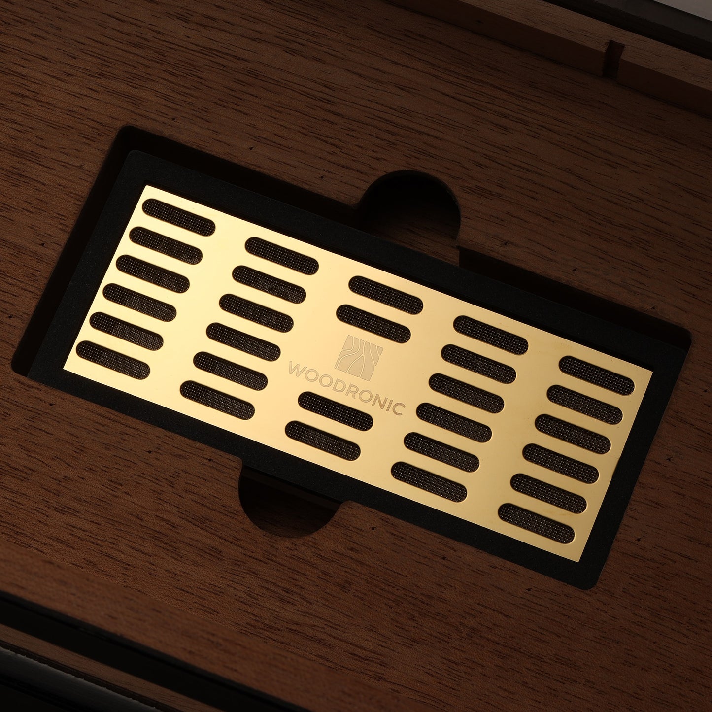 Close-up of branded gold humidity tray inside cigar humidor, designed for Boveda packs to maintain consistent humidity.