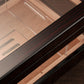 Close-up of high-gloss ebony wood finish on cigar humidor, highlighting premium craftsmanship and smooth, reflective surface.