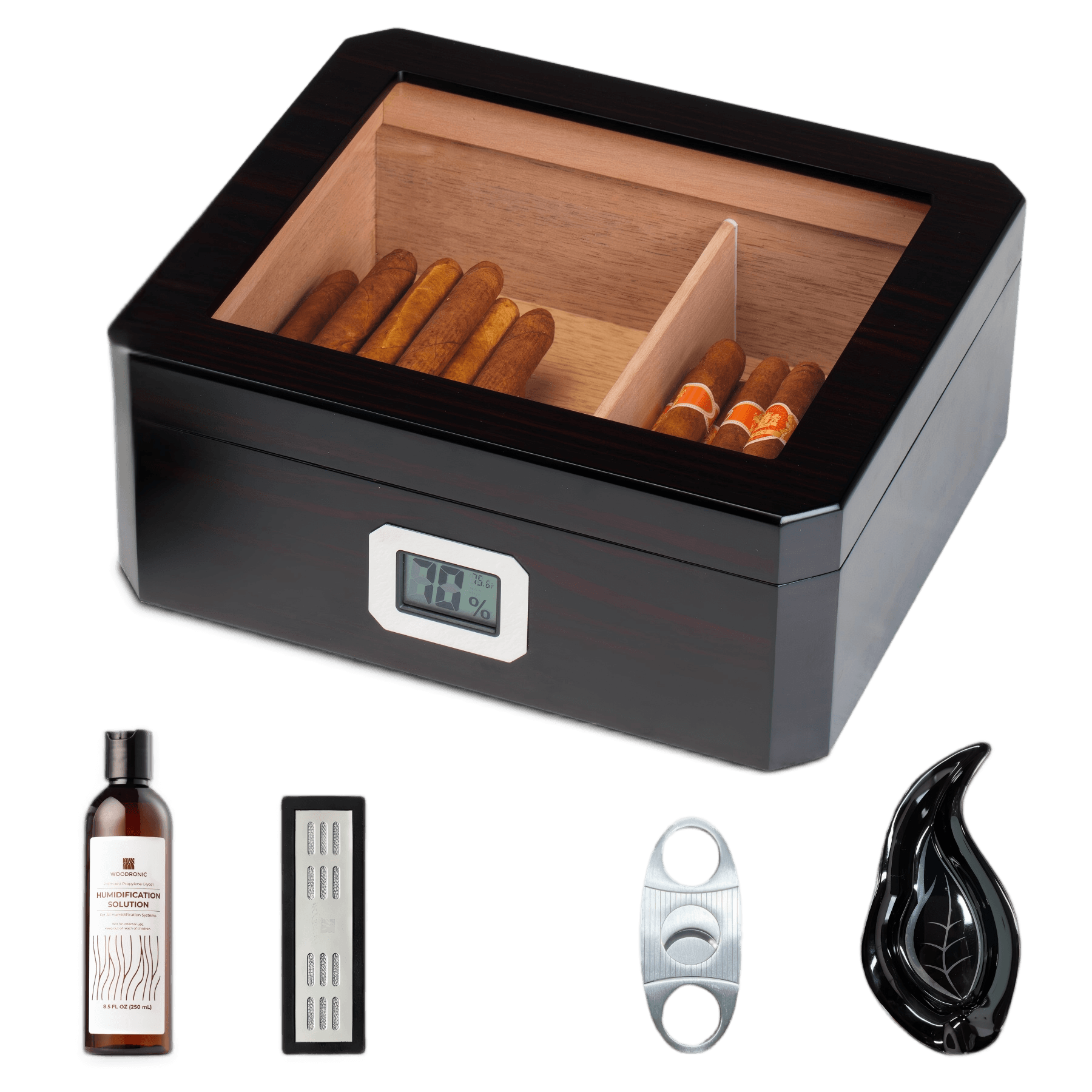 A dark wooden cigar humidor with a glass top and digital hygrometer, displayed with its full accessory set: humidification solution, crystal gel humidifier, stainless steel cigar cutter, and leaf-shaped cigar ashtray, against a white background.