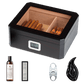 A dark wooden cigar humidor with a glass top and digital hygrometer, displayed with its full accessory set: humidification solution, crystal gel humidifier, stainless steel cigar cutter, and leaf-shaped cigar ashtray, against a white background.