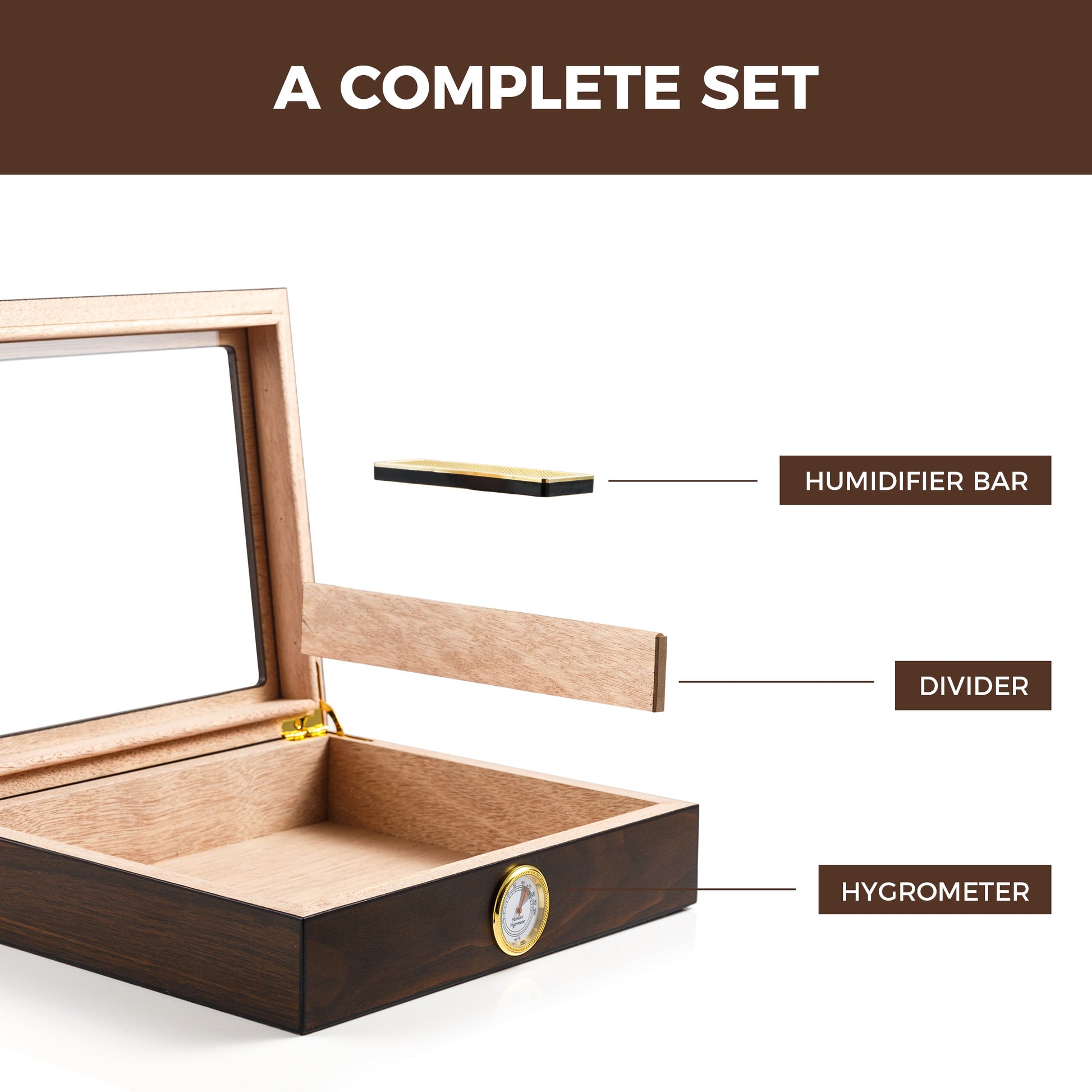 An empty open cigar humidor with labeled components: HUMIDIFIER BAR, DIVIDER, and HYGROMETER, presented against a clean white background to highlight the complete set.