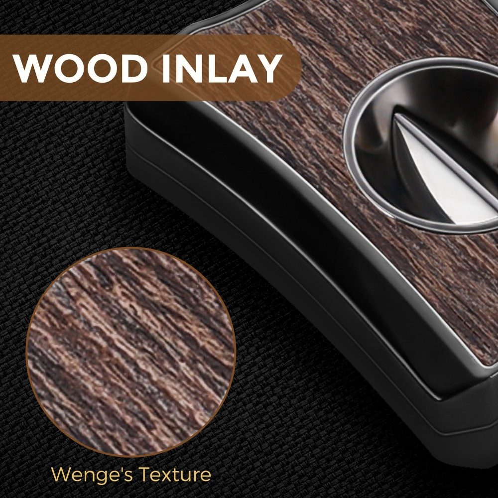 Extreme close-up of the wenge wood grain inlay on the cigar cutter’s front panel, highlighting natural striped wood texture and polished stainless steel V-cut blade.