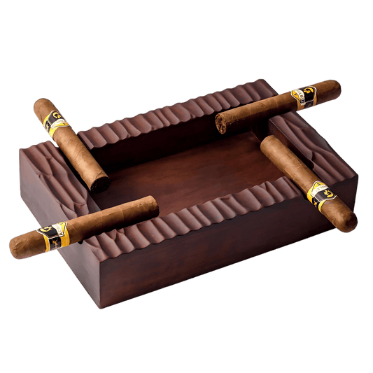 Rectangular solid walnut cigar ashtray with 4 cigar slots and hand-carved texture, holding premium cigars.