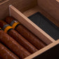 Close-up of premium cigars and foam humidifier inside the cedar-lined humidor, showcasing organized storage.