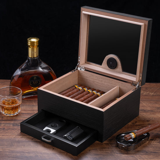 Open humidor displayed with premium cigars and whiskey, perfect for elegant home bar decor and gifting.