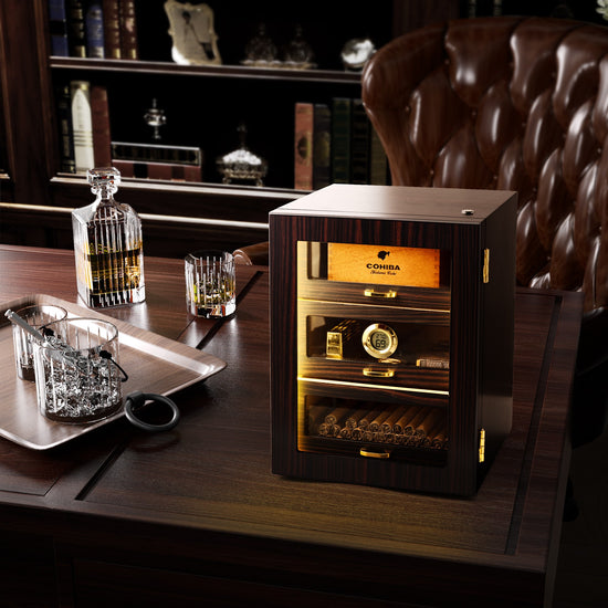 Ebony wood humidor displayed in a sophisticated study, paired with whiskey and leather decor for elegant cigar enjoyment.