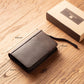 Woodronic branded leather cigar case with labeled dimensions (8.26" x 5.5" x 1.77"), displayed next to its kraft gift box on a wooden surface.